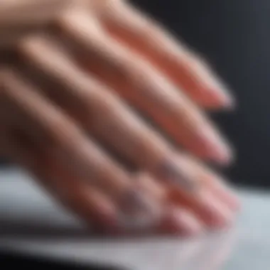 Demonstration of a nail application technique using glitter flakes.