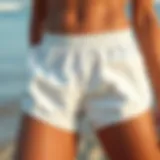Texture and Design of White Swimsuit Shorts A close-up view of white swimsuit shorts on a sandy beach, showcasing their texture and design.