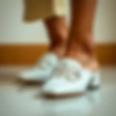 Close-up of white square toe mules showcasing intricate design details